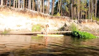 Tattooed Babe Strips and Swims on a SUP Board in the Forest River